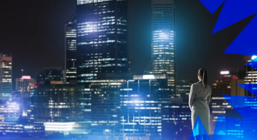 A woman looks out at a futuristic, illuminated city—a visual representation of the global megatrends influencing urban and technological development