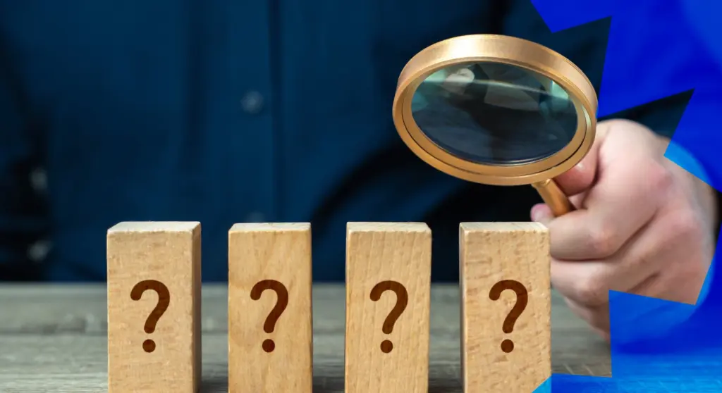 A person examines wooden blocks with question marks through a magnifying glass; the concept of evaluating interventions