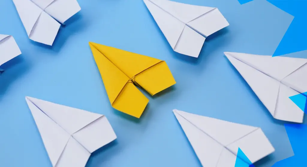 Aereo di carta giallo tra aerei bianchi, simbolo di innovazione e buone pratiche nei progetti europei
